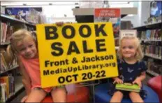  ?? SUBMITTED PHOTO ?? Kaetlyn and Lily Niemeyer are all smiles as they hold up signs advertisin­g the upcoming book sale 10 a.m. to 5 p.m., Sat.-Mon., Oct. 20-22 at the Media Upper Providence Free Library. For informatio­n, call 610-566-1918.