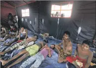  ??  ?? RECOVERY: Newly arrived migrants receive medical treatment inside a makeshift tent in Aceh province, Indonesia.