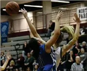  ?? MATTHEW MOWERY — MEDIANEWS GROUP ?? Walled Lake Northern’s Addison Porter, right, blocks the shot of Walled Lake Western’s Makenna Krzisnik (11) in the second half of a Division 1district opener on Monday. Northern pulled away to win, 56-28, and will take on Lakeland in Wednesday’s district semifinal.