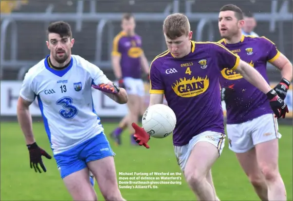  ??  ?? Michael Furlong of Wexford on the move out of defence as Waterford’s Donie Breathnach gives chase during Sunday’s Allianz FL tie.