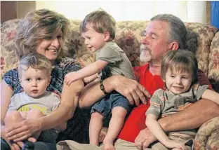  ?? JACOB LANGSTON/STAFF PHOTOGRAPH­ER ?? Mike and Lynne Belisle are raising their grandsons, from left, Aiden, 2 1 ⁄ , Nicholas, 1 ⁄ , and Joey, 5, in 2 2 Quincy, near the Florida-Georgia line. Mike Belisle’s daughter and her husband died of an opioid overdose.