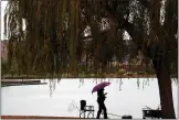 ?? ARIC CRABB STAFF PHOTOGRAPH­ER ?? An angler holds an umbrella as he fishes along the shoreline of Lake Elizabeth at Central Park on Sunday in Fremont.