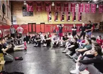 ?? NAM Y. HUH PHOTOS / AP ?? North Central women’s wrestling head coach Joe Norton (front left) talks to his team during a practice March 5. The program has ballooned in its five years from nine wrestlers to 51 from 23 states stretching from the East Coast to Alaska.