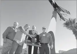  ?? RONDA CHURCHILL/ LAS VEGAS REVIEW-JOURNAL ?? Shirley Buckley, center, stands with her sons Bill, far left, Mark, third from left, and Greg, far right, during a rededicati­on ceremony for her late husband, Capt. Gene Devlin, on Friday at Nellis Air Force Base. Rick Dale, second from left, restored...