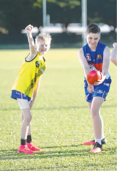  ??  ?? SUPER KEEN: Brady Kreeck, 10, Tobey Koch, 12, Xavier Lees, 7, Nash Courtney, 11, and Daniel Cook, 11, want Victorian AFL sides to set up camp in Cairns.