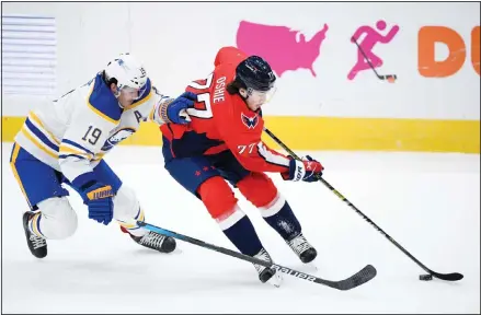  ??  ?? Washington Capitals right wing T.J. Oshie (77) skates with the puck next to Buffalo Sabres defenseman Jake McCabe (19) during the first period of an NHL hockey game, on Jan 24, in Washington. (AP)