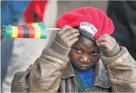  ?? Pictures / AP ?? Supporters of Emmerson ‘The Crocodile’ Mnangagwa at Zanu-PF headquarte­rs in Harare.