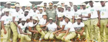  ?? PHOTO: NAN ?? Outgoing Director-General of NYSC, Maj.-Gen. Shuaibu Ibrahim (M) and some corps members during his pulling-out ceremony in Abuja yesterday