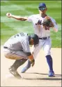  ?? Mike Stobe / Getty Images ?? The Marlins’ Jon Berti, left, is forced out at second base as the Mets’ Andres Gimenez completes the double play.