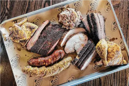  ?? Photos by J.C. Reid / Contributo­r ?? Roegels Barbecue expands on its tradition of serving up great food by opening a branch in Katy.