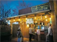  ??  ?? Customers wait to place orders Tuesday (Nov. 17) at Taos Mesa Brewing Tap Room’s curbside pickup area, 201 Paseo del Pueblo Sur.