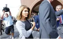  ?? AP FILE PHOTO/ STEVEN SENNE ?? Actress Lori Loughlin departs federal court in Boston after a hearing in a nationwide college admissions bribery scandal. The “Full House” actress has reported to a federal prison in California to begin serving her two-month sentence for her role in the scandal.