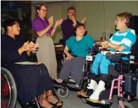  ?? The Associated Press ?? ■ Judy Heumann, center, is applauded during her swearing-in as U.S. Assistant Secretary for Special Education and Rehabilita­tive Service by Judge Gail Bereola, left, on June 9, 1993, in Berkeley, Calif. Standing at left is Berkeley Mayor Loni Hancock with sign language interprete­r Joseph Quinn, and Julie Weissman, right, in attendance with a large audience.