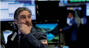  ?? — Reuters ?? A trader works on the trading floor at the New York Stock Exchange in Manhattan.