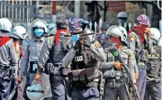  ??  ?? Myanmar police crack down on demonstrat­ors on the second day in Yangon on Sunday