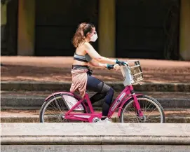  ?? Yi-Chin Lee/Staff file photo ?? Christian Aguilera tests a repaired bike on Feb. 1. City Council granted $500,000 on Wednesday to keep the BCycle system afloat until Metro’s version launches.