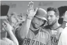  ?? NAM Y. HAM/AP ?? The Diamondbac­ks' Paul Goldschmid­t celebrates with teammates after homering against the Cubs in the ninth inning on Thursday. It was his third homer of the game.