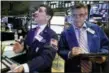  ?? RICHARD DREW — THE ASSOCIATED PRESS FILE ?? Trader Peter Mazza, left, works with trader Daniel Trimble on the floor of the New York Stock Exchange.