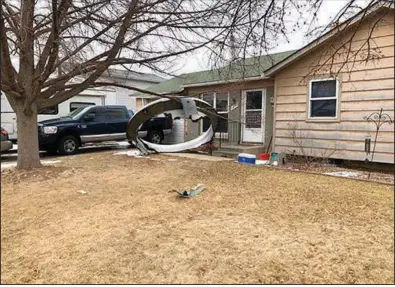  ?? (AP/Broomfield Police Department) ?? Debris from a Boeing 777 airliner is scattered Saturday in the front yard of a house in Broomfield, Colo.