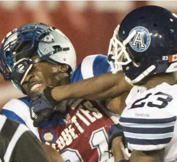  ?? GRAHAM HUGHES/THE CANADIAN PRESS ?? Argo Vincent Agnew hits Mike Edem of the Alouettes in the second half of Friday night’s game in Montreal.