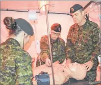  ?? ERIN POTTIE/CAPE BRETON POST ?? Army reservists, from left, Sgt. Brittany Robinson, Cpl. Candice Ziolkowski and Cpl. Patrick Lamarche used some of their training as medical technician­s to check the vital signs of a dummy patient at Saturday’s open house at Victoria Park in Sydney.