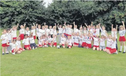  ??  ?? Year 2 pupils at Westfields Infant School, in Yateley, in hand-painted national shirts for their ‘mini World Cup’ five-a-side tournament.