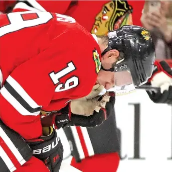  ?? JONATHAN DANIEL/GETTY IMAGES ?? Blackhawks captain Jonathan Toews leaves the ice in some pain toward the end of the game Thursday night against the Carolina Hurricanes at the United Center.