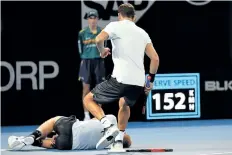  ?? SAEED KHAN/GETTY IMAGES ?? Grigor Dimitrov rushes to help Kyle Edmund, who fell due to a leg injury during their match Friday at the Brisbane Internatio­nal tennis tournament. Dimitrov eventually beat Edmund 6-3, 6-7 (3), 6-4.