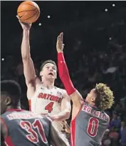  ?? Ron Irby Associated Press ?? FLORIDA GUARD Egor Koulechov shoots over Gardner-Webb guard Jamaal Robateau.