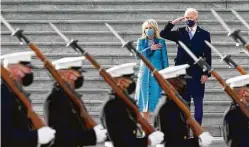  ?? J. Scott Applewhite / Associated Press ?? Above, President Joe Biden and his wife, Jill, watch a military guard pass in review.