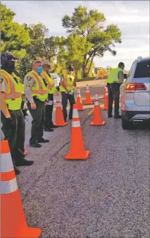  ?? COURTESY TAOS COUNTY SHERIFF’S OFFICE ?? Deputies speak to drivers at a one of two checkpoint­s operated at the Colorado border last week. The checkpoint­s were set up to both check drivers for intoxicati­on and inform them about New Mexico’s emergency health orders.