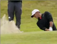  ?? ALASTAIR GRANT — THE ASSOCIATED PRESS ?? First-round co-leader Brooks Koepka plays out of a bunker on the 18th hole at Royal Birkdale.