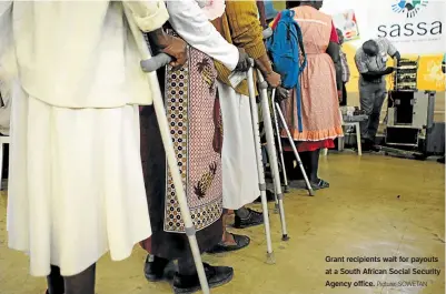  ??  ?? Grant recipients wait for payouts at a South African Social Security Agency office. Picture: SOWETAN