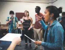  ?? Matt Rourke, The Associated Press ?? Director Jasmine Barksdale and Off the Beat singers rehearse at the University of Pennsylvan­ia.