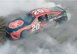  ?? JAMES GILBERT/GETTY ?? Joe Gibbs Racing driver Christophe­r Bell celebrates with a burnout after winning Sunday’s NASCAR Cup Series at New Hampshire Motor Speedway.