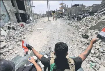  ??  ?? Members of the Emergency Response Division celebrate in the Old City of Mosul, Iraq. — Reuters photo