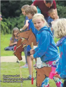  ??  ?? On your marks! Children prepare to set off on their steeds.