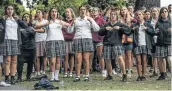  ?? Picture: CARL COURT/GETTY IMAGES ?? SOLIDARITY: Schoolgirl­s make their feelings known about the massacre which caused so much pain.