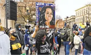  ?? TIMOTHY D. EASLEY AP ?? A protester holds up a painting of Breonna Taylor during a rally on the anniversar­y of her death Saturday at Jefferson Square Park in Louisville, Ky.