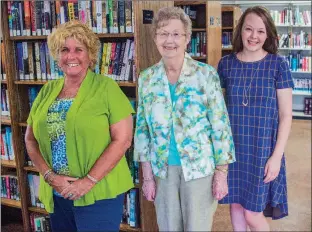  ?? WILLIAM HARVEY/THREE RIVERS EDITION ?? Cave City Library board member Jill Pettersen, from left, librarian Vera Anderson and Friends of the Library member Jessica Anderson stand inside the Cave City Library. The new library opened in May in the former Bank of Cave City building, and the...