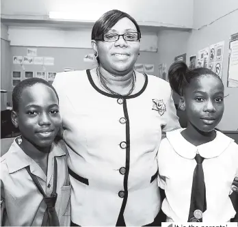  ?? FILE ?? Principal of Rollington Town Primary, Dr Margaret Bailey, flanked by two of her students.