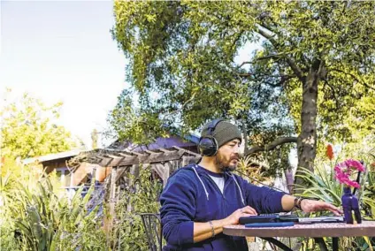  ?? DANIA MAXWELL LOS ANGELES TIMES ?? Breeze Prado makes use of the Wi-Fi service at GreenStone Farm to do his work as a recording engineer in the garden setting. Art activities, a romantic dinner or simply roaming the grounds are among other ways garden rentals are put to use.