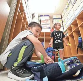  ?? DAN POWERS/USA TODAY NETWORK-WISCONSIN ?? Kindergart­en student Nic Xiong empties his backpack during the first day of school at Edison Elementary School in Appleton last year.