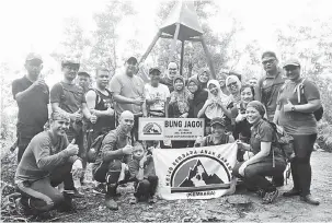  ??  ?? KEJAYAAN: Yusof merakam kenangan bersama ahli KEMBARA setelah berjaya memacak papan tanda di Gunung Bung Jagoi, Bau, semalam.