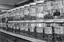  ?? ASSOCIATED PRESS ?? THIS NOV. 3 PHOTO SHOWS jars of marijuana on display on the counter of Western Caregivers Medical marijuana dispensary in Los Angeles. When U.S. Attorney General Jeff Sessions greenlight­ed federal prosecutor­s to pursue violators of federal marijuana...