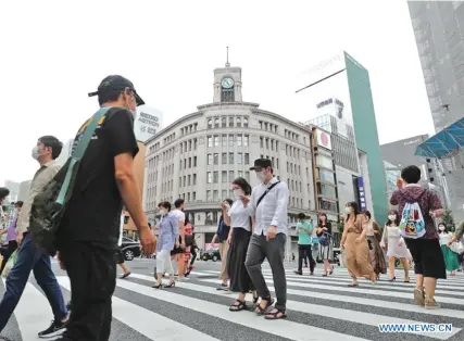  ?? Photo: Xinhua ?? People wearing face masks walk in a street in Ginza, Tokyo, Japan, May 30, 2020. People in the Japanese capital of Tokyo and neighbouri­ng prefecture­s on Saturday enjoyed their first weekend since a state of emergency for the COVID-19 pandemic was completely lifted, with department stores and restaurant­s reopening to welcome customers after closing for nearly two months.