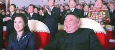  ?? Agence France-presse ?? ↑ Kim Jong Un and his wife Ri Sol Ju watch a performanc­e at the Mansudae Art Theatre in Pyongyang on Wednesday.
