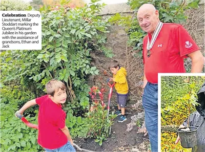  ?? ?? Celebratio­n Deputy Lieutenant, Millar Stoddart marking the Queen’s Platinum Jubilee in his garden with the assistance of grandsons, Ethan and Jack
