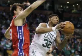  ?? ASSOCIATED PRESS ?? Celtics guard Marcus Smart (36) makes a move against 76ers forward Dario Saric (9) in Game 1 Monday night. Saric had an impact in Game 2, but that was not enough to keep the Celtics from taking a 2-0 series lead with a 108-103 victory Wednesday night...