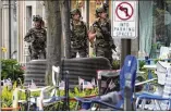  ?? NAM Y. HUH/AP ?? Law enforcemen­t officers search the area Monday after a mass shooting at the Highland Park Fourth of July parade in downtown Highland Park, Illinois, a Chicago suburb.